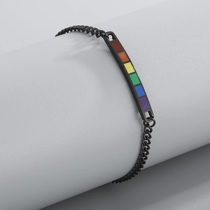 Detail of a black chain bracelet featuring a vibrant rainbow LGBTQ pride metal bar insert