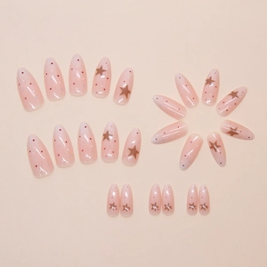 Detail of almond-shaped press-on nails with colorful dots and gold star sequins