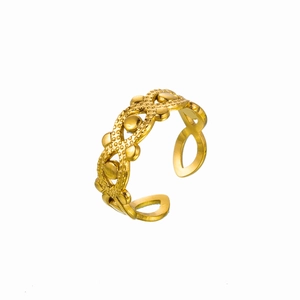 Macro detail of golden hollow geometric flower ring featuring intricate dotted textures