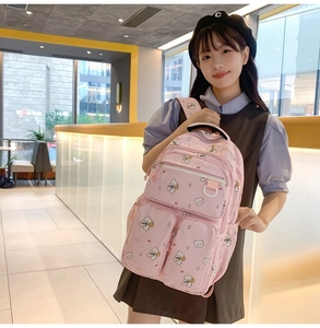 Detailed view of pink school backpack featuring cute bear prints and multi-pocket design