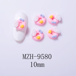 Macro shot of 10mm resin pink donut nail charms with wings and bow decorations