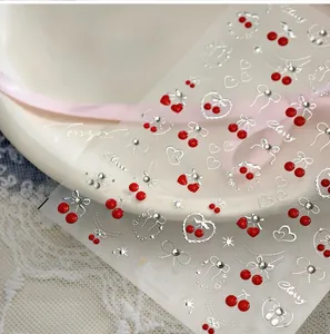 Detailed view of TL-401 cherry nail stickers with 3D red fruit and silver bow designs