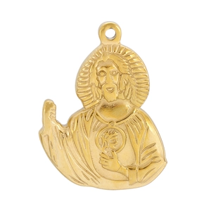Close-up of golden stainless steel Jesus portrait pendant with polished metallic finish