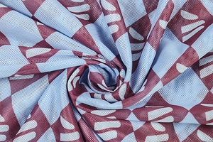 Macro detail of breathable mesh fabric with red and blue geometric abstract prints