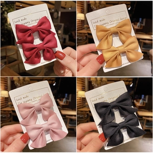 Handmade fabric bow hair clips for girls in red, yellow, pink, and black colors