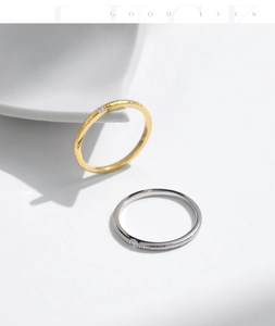 Close-up of gold and silver textured minimalist rings on a white display dish
