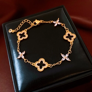 Detailed macro view of 24K gold plated hollow flower bracelet with sparkling zircons