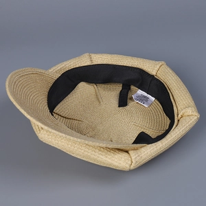 Beige woven newsboy cap interior view with black sweatband and high-quality straw texture