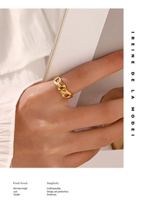 Detailed view of adjustable gold-plated geometric ring with irregular texture on model