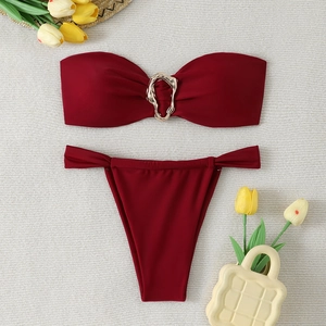 Detail of burgundy bandeau bikini top with golden ring and matching high-cut bottoms