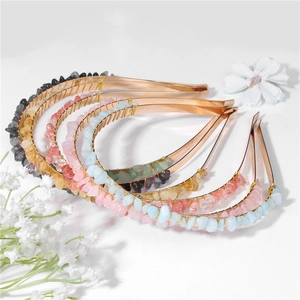 Detailed view of colorful natural stone chips hand-wrapped on a golden metal headband