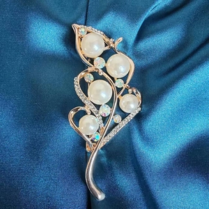 Baroque rose gold leaf brooch with white pearls and sparkling rhinestones on blue silk