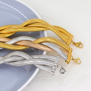 Detailed macro view of triple-strand twisted snake chains in gold silver and rose gold