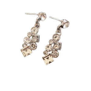 Elegant geometric diamond-encrusted silver stud earrings set on a clean white background