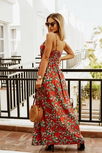 Detail of red floral bohemian maxi dress with delicate spaghetti straps and open back