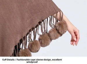Detail of brown knitted poncho sleeve with decorative tassels and plush faux fur pom-poms