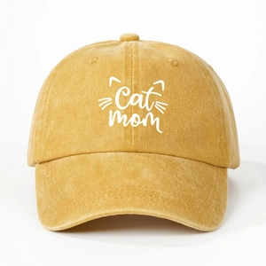 Detailed macro view of mustard yellow washed cotton fabric and Cat Mom embroidery