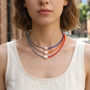 Detail of colorful MGB glass beads and irregular freshwater pearl on a beaded necklace