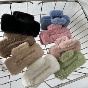 Macro view of multi-colored plush hair claws in a metal basket with soft fur texture