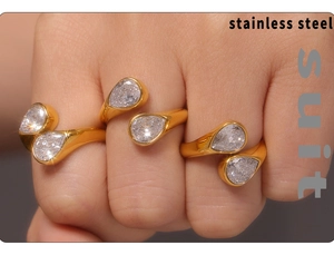 Detailed view of three 18k gold-plated rings with double pear-cut cubic zirconia stones