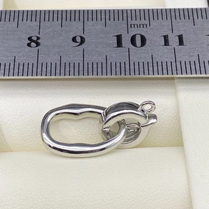Detail of S925 sterling silver jewelry clasp with scale measurement for size reference