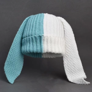 Close-up of blue and white color-block knitted hat featuring long bunny ears detail