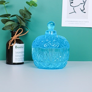 Detail of sky blue embossed snowflake storage jar with textured glass finish