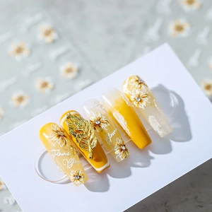 Daisy nail art stickers with yellow gradient base and gold leaf metallic accents