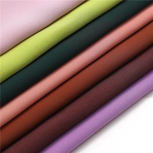 Macro shot of multi-color pearl chiffon fabric showing fine crinkle texture and soft drape