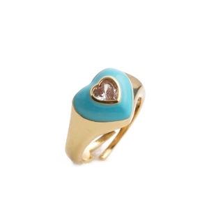 Close-up of gold-plated heart ring with sky blue enamel and center gemstone detail