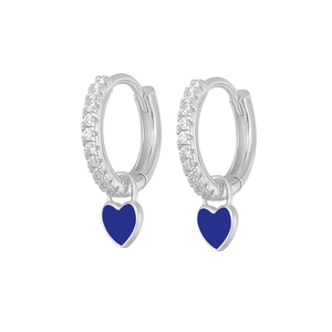 Macro shot of silver-colored heart earrings with blue enamel and sparkling rhinestones
