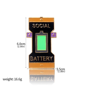 Detailed view of enamel social battery pin with size specs 6.0x3.5cm and weight 16.6g