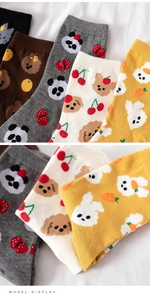 Detail of colorful cotton crew socks featuring cute cartoon animal patterns and vibrant colors