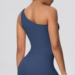 Detail of navy blue one-shoulder sports bra showing soft brushed texture and elastic fit