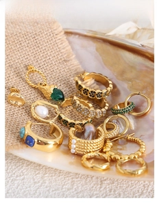 French vintage style gold earrings with gemstones and pearls on shell display