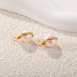 Detail of handcrafted gold wire wrapped baroque pearls for DIY jewelry making