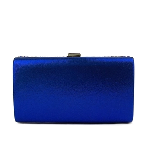 Detail of royal blue evening clutch bag featuring a rectangular metal clasp and matte finish