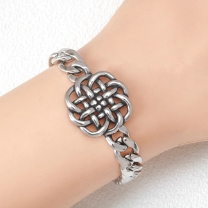 Men's stainless steel Cuban link bracelet with Celtic knot centerpiece on wrist