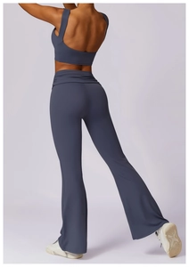 Rear view of high-waist flared yoga pants and backless sports bra in greyish blue