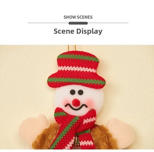 Close-up of a plush Christmas snowman hanging ornament with a striped knit hat and scarf