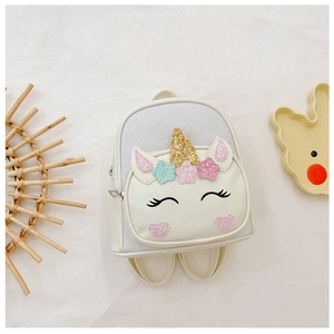 Detail of unicorn backpack with sparkling gold horn and iridescent sequins for girls