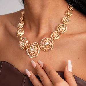 Detailed view of luxury hollow rose necklace with sparkling rhinestones on golden petals