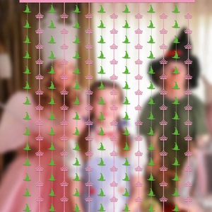 Vertical fringe curtain featuring pink crown and green witch hat paper cutouts