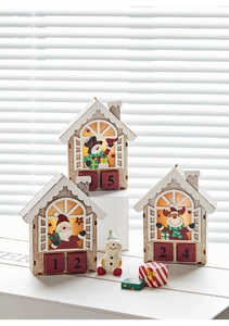 Three wooden Christmas advent calendar houses with LED lights and numeric drawers