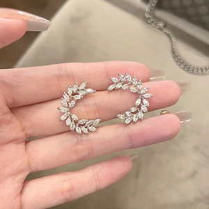 Elegant silver leaf stud earrings with sparkling cubic zirconia in a crescent shape