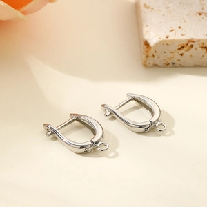 Macro shot of silver U-shaped earring hooks with attachment loops for DIY jewelry making