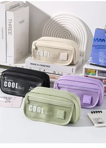 Stack of canvas pencil cases in four colors showing mesh pockets and durable fabric