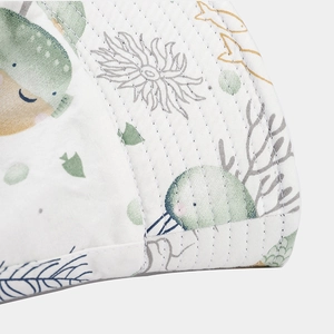 White reversible sun hat for children with sea life prints and quilted stitching detail