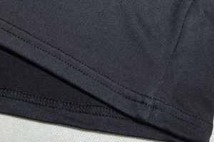 Detail of high-quality double-needle stitching on a black knitted two-piece set
