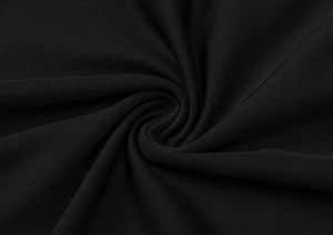 Detail of black knitted fabric showing premium textile texture and elegant soft drape